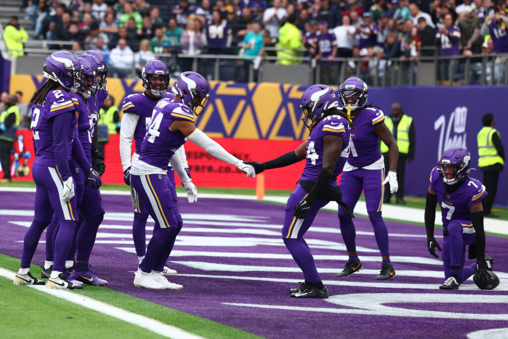 Minnesota Vikings safeties Camryn Bynum and Josh Metellus celebrate.